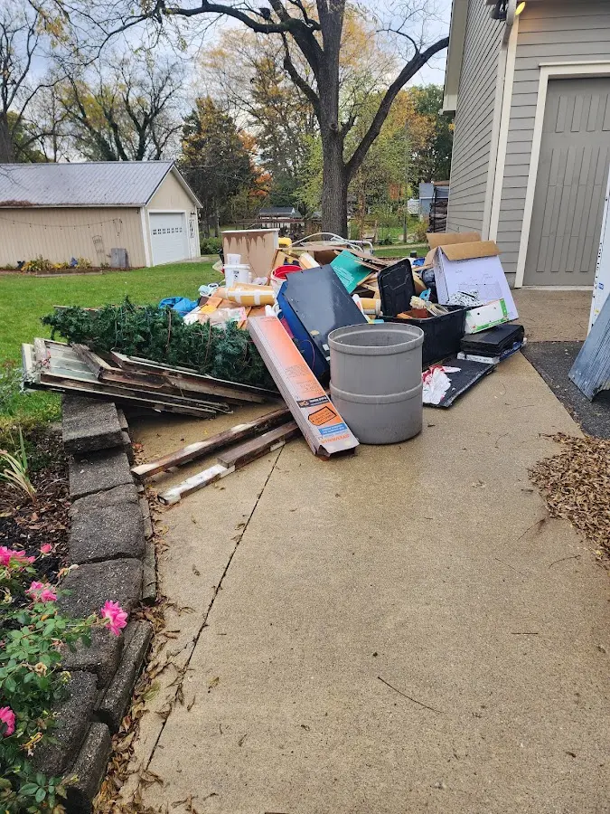 Dumpster being loaded with debris for Roofing Dumpster Rental in Watauga
